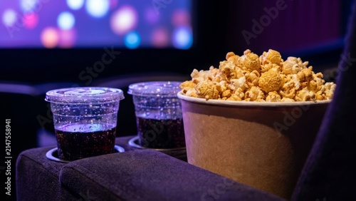 Lifestyle - Bucket of popcorn and two cups of soda in a movie theater