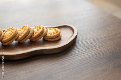 Close-up of cream sandwich biscuit on wooden serving board