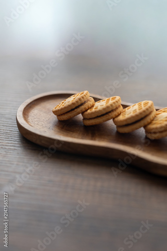 Close-up of cream sandwich biscuit on wooden serving board