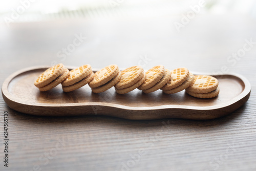 Close-up of cream sandwich biscuit on wooden serving board