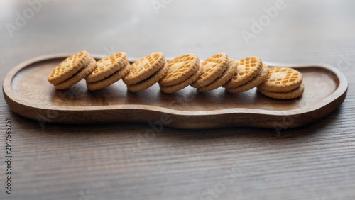 Close-up of cream sandwich biscuit on wooden serving board