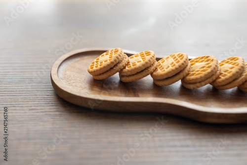 Close-up of cream sandwich biscuit on wooden serving board
