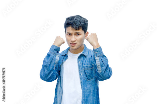 Konstfotografi Frustrated young man with clenched fists isolated on white background