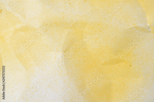 Bright yellow crumpled paper texture with spray paint finish for creative abstract background