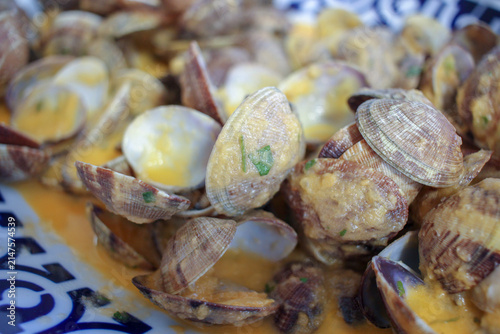 Close Up View of Cooked Clams in Creamy Garlic Sauce Served on a Plate