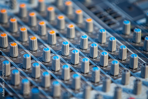 Audio mixing console knobs close-up, professional sound equipment
