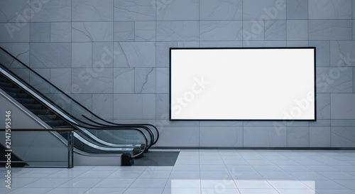Blank advertising billboard in modern shopping mall. White digital display screen template mockup on grey marble wall. Indoor advertising space near escalator. Minimalist commercial background.
