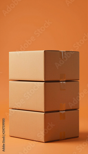 A vertical stack of three cardboard boxes on plain background