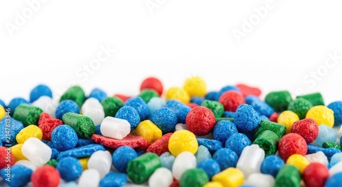 A macro view of colorful recycled plastic fragments and regrind pellets ready for manufacturing, showcasing sustainable circular economy, synthetic, eco-friendly, heap