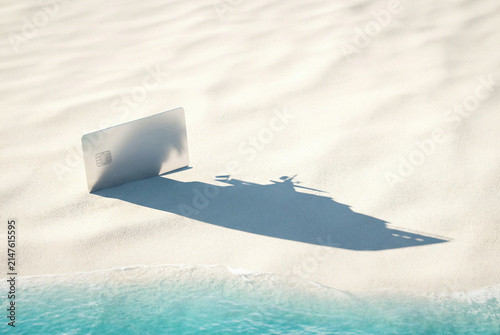 Credit card standing on white sand casting cruise ship shadow