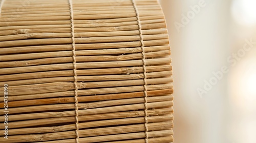 Close Up of a Rolled Bamboo Blind with Natural Texture and Soft Bokeh Background