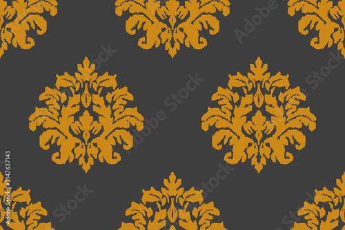 Golden damask wallpaper with a seamless ikat-weave pattern on a dark grey background. 