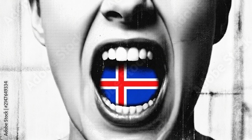 Close-up of a person screaming with the Icelandic flag inside their open mouth, expressing national identity or protest.