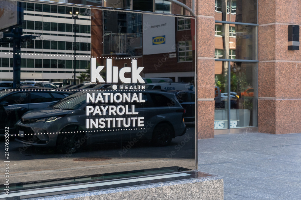 Fototapeta premium Toronto, Ontario, Canada - August 5, 2026: A directory sign marks Klick Health and National Payroll Institute outside the office building on Bloor Street East in Toronto, Ontario, Canada.