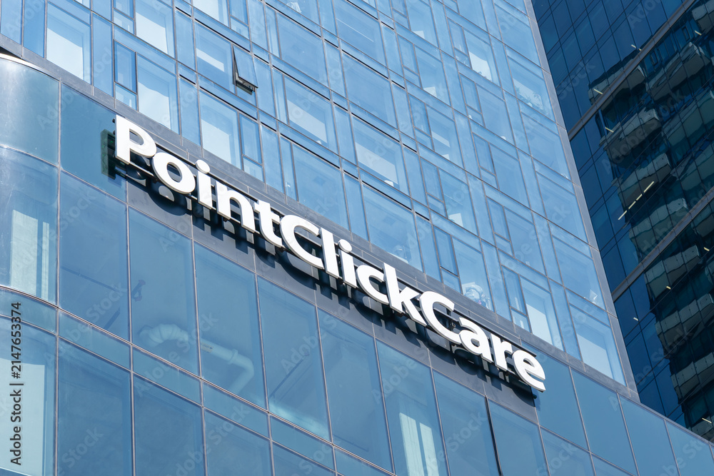 Fototapeta premium Toronto, Ontario, Canada - August 5, 2026: Close up of PointClickCare sign on the building at The Well on Spadina Ave in downtown Toronto, Canada. PointClickCare Technologies is a healthcare software