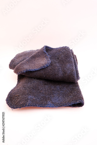 Konstfotografi Dark blue microfiber cleaning cloth showing visible dirt and signs of wear after prolonged use