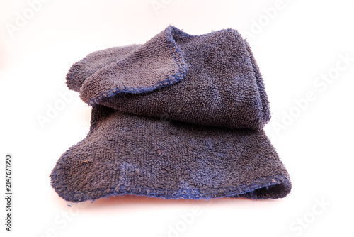 Bild auf Leinwand Dark blue microfiber cleaning cloth showing visible dirt and signs of wear after prolonged use