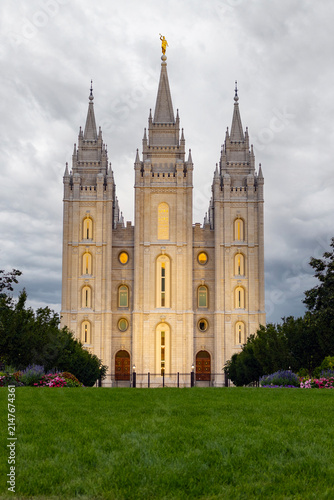 The Salt Lake Temple stands majestically in Temple Square in Salt Lake City, Utah, showcasing stunning Gothic and Romanesque architectural details. Its granite spires rise against a clear blue sky, su