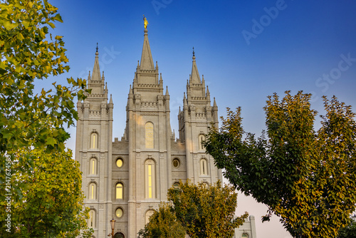 The Salt Lake Temple stands majestically in Temple Square in Salt Lake City, Utah, showcasing stunning Gothic and Romanesque architectural details. Its granite spires rise against a clear blue sky, su