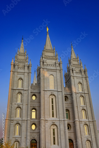 The Salt Lake Temple stands majestically in Temple Square in Salt Lake City, Utah, showcasing stunning Gothic and Romanesque architectural details. Its granite spires rise against a clear blue sky, su