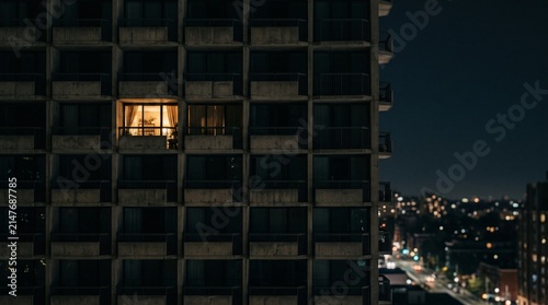 Illuminated Office Building Architecture Against a Dark Urban Night Sky with Glowing Windows