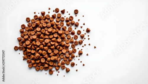 A large amount of dark brown coffee beans in the foreground. The beans are tightly packed together and seem to be evenly ground