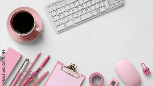 Top view of a modern business workspace with computer keyboard, mouse, cup of coffee, stationery, pens, clips, pink adhesive tape, and planners arranged on an isolated white background with clean copy