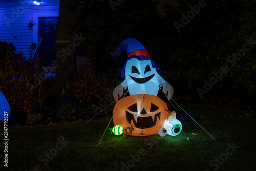 Halloween pumpkin with the ghost in the garden