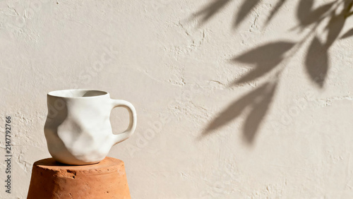 Minimalist White Ceramic Mug on Terracotta Pedestal
