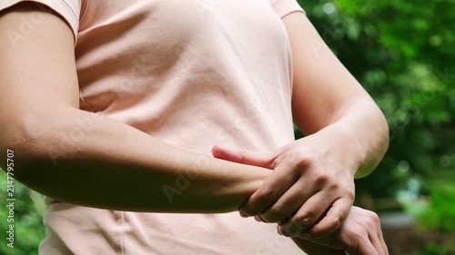 Woman massaging a painful and numb area, symbolizing joint pain, injury, or inflammation, and emphasizing the importance of seeking medical attention, proper care, and musculoskeletal rehabilitation.
