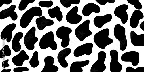 Seamless cow print pattern with classic black and white spots. Classic cow print seamless background for textile and fabric designs. 