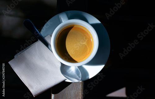 Hot coffee in a mug, and the shadows of the morning light.