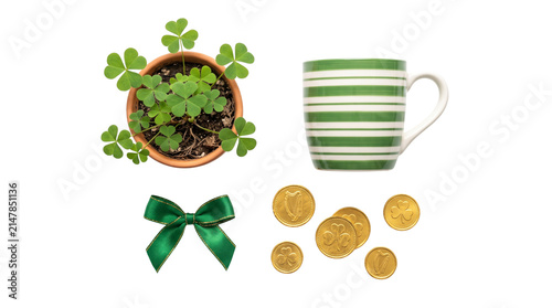 Saint Patrick's Day flat lay with green shamrock plant, striped ceramic mug, gold coins and satin bow, festive Irish holiday elements on white background