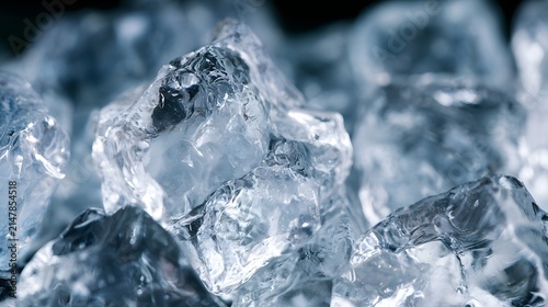 Close up of translucent ice cubes showing sharp crystalline edges and smooth frozen surfaces under cool blue lighting