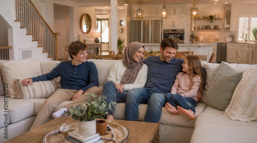 Smiling Muslim Family Sitting Together in Modern Living Room