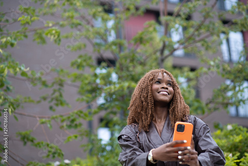 A woman using a mobile phone standing outdoors