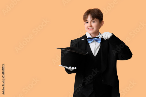 Canvas Print Little magician with wand and hat on beige background