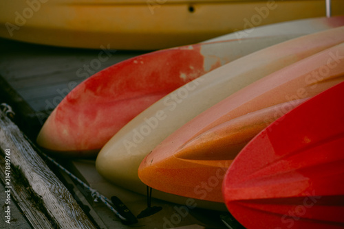 Colorful kayak bows lined up on a dock
