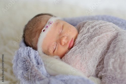 Canvas Print Swaddled newborn baby girl sleeping peacefully