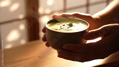 Hands Holding Bowl of Soup.