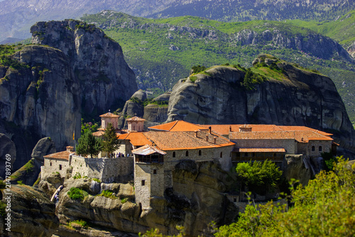 Obraz na plátne The Holy Monastery of Varlaam in Meteora, Greece, with tourists ascending the stairs on a sunny day