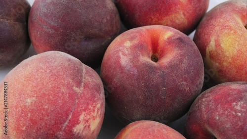 Ripe peaches fill closeup frame. Peaches showcase fresh harvest, seasonal produce, juicy fruit ideal for healthy nutrition, farm marketing, grocery advertising, natural food promotion. 4k footage