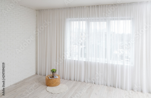 Canvas Print Coffee table and plant near light curtain in living room