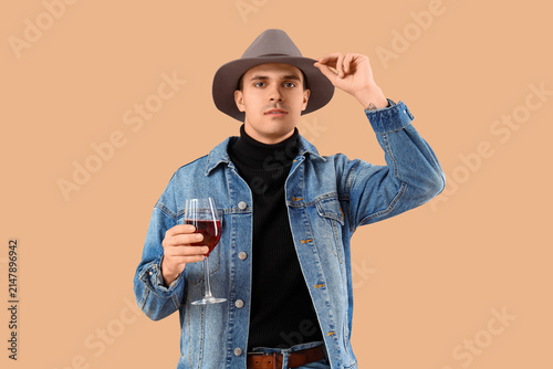 Young man with glass of win...