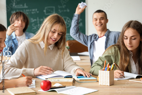 Female students studying at table in classroom