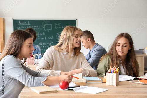 Female students studying at table in classroom