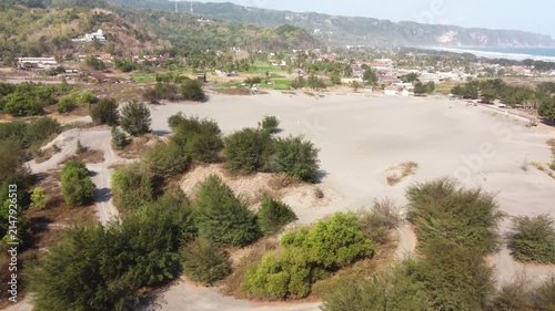 Aerial View of Gumuk Pasir Parangkusumo Sand Dunes with Coastal Village and Hills in Yogyakarta, Indonesia