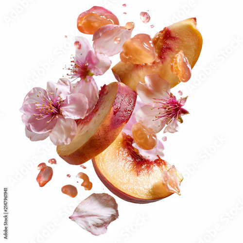 Peach slice with pink flower petals and juice droplets flying in air, creating fresh and vibrant composition full of natural beauty and color isolated on transparent background