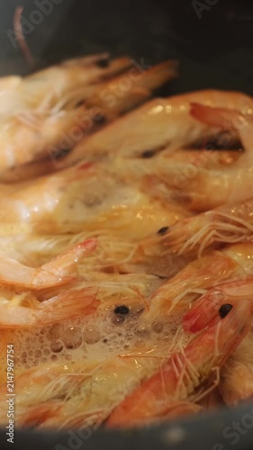 Vertical video. Tiger prawns fried in pan. Seafood. Shrimps cooking. Food prep.