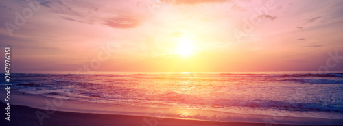 Seascape in the evening. Sunset over the sandy beach. Nature landscape